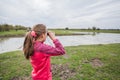 Little girl observing with binoculars nature landscape on spring day Royalty Free Stock Photo