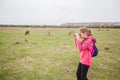 Little girl observing with binoculars nature landscape on spring day Royalty Free Stock Photo