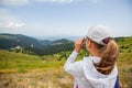 Little girl observing with binoculars nature landscape on spring day Royalty Free Stock Photo