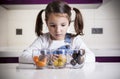 Little girl observing cherry tomatoes varieties colors