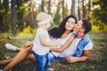 Little girl one year on the background of parents resting lying on grass learning to walk on nature in the park. The first steps Royalty Free Stock Photo