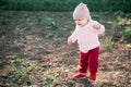 Little girl one year playing in the village outdoors