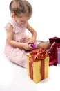 Little girl opening Christmas presents Royalty Free Stock Photo