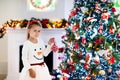 Little girl opening Christmas presents at fire place Royalty Free Stock Photo