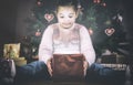 Little girl opening he present under Christmas tree Royalty Free Stock Photo