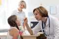 Little girl opening mouth for checkup at doctors office