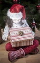 Little girl opening he present under Christmas tree Royalty Free Stock Photo