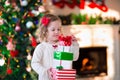 Little girl opening presents on Christmas morning