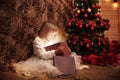 Little girl opens magic Christmas gift box Royalty Free Stock Photo