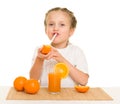 Little girl with oranges drink juice with straw Royalty Free Stock Photo