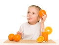 Little girl with oranges drink juice with straw Royalty Free Stock Photo