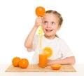 Little girl with oranges drink juice with a straw Royalty Free Stock Photo