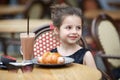 Little girl at outdoor cafe on warm summer day Royalty Free Stock Photo