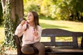 Little girl outdoors at beautiful autumn day blows soap bubbles Royalty Free Stock Photo