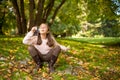 Little girl outdoors at beautiful autumn day blows soap bubbles Royalty Free Stock Photo