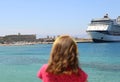 little girl red dress looks cruise liner Royalty Free Stock Photo