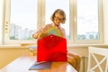 Little girl is packing his school backpack sitting on the desk. School, education, knowledge and children. Royalty Free Stock Photo