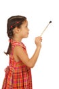 Little girl with a paintbrush, side view Royalty Free Stock Photo