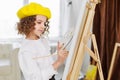 Little girl painting a picture in a studio or art school. Creative pensive painter child paints a colorful picture on Royalty Free Stock Photo