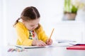 Little girl painting and writing Royalty Free Stock Photo