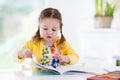 Little girl painting and writing Royalty Free Stock Photo