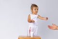 Little girl in pajamas, and a baby kit for brushing teeth. White background and empty space. Hygiene