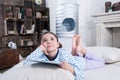 Little girl in pajamas lying on bed with digital tablet Royalty Free Stock Photo