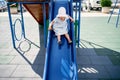 Little girl in a panama slides down a slide with her mouth open Royalty Free Stock Photo