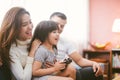 Little girl and parent family playing video game at home. Royalty Free Stock Photo