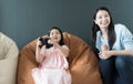 Little girl and parent family playing video game at home. Royalty Free Stock Photo