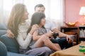 Little girl and parent family playing video game at home. Royalty Free Stock Photo