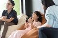 Little girl and parent family playing video game at home. Royalty Free Stock Photo