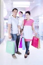 Little girl and parents shopping at mall