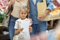 Little Girl with Parents in Supermarket Royalty Free Stock Photo