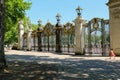 Little girl walking past a stunning gate in central London