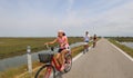 Little girl pedaling a bicycle on the bike path together with he Royalty Free Stock Photo