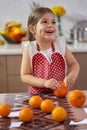 Little girl peeling oranges