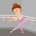 Little girl performing ballet steps in her dance academy.