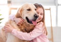 Little girl petting golden retriever dog Royalty Free Stock Photo