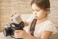 Little girl photographer holding old vintage film photo camera Royalty Free Stock Photo