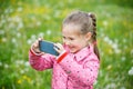 Little girl photographing with her smart phone Royalty Free Stock Photo