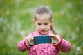 Little girl photographing with her smartphone Royalty Free Stock Photo