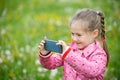 Little girl photographing with her smartphone Royalty Free Stock Photo