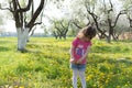 Little girl pick up dandelion on the lawn Royalty Free Stock Photo