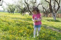 Little girl pick up dandelion on the lawn Royalty Free Stock Photo