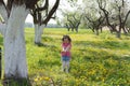 Little girl pick up dandelion on the lawn Royalty Free Stock Photo