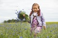 Little girl picking blue flowers