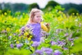 Little girl picking wild flowers in a field Royalty Free Stock Photo