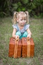 Little girl in pigtails lifting baskets