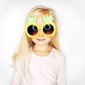 Little girl in pineapple sunglasses in studio